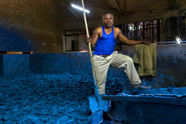 A worker at the Savonnerie Industrielle de Butembo (SAIBU) whose main product is bars of blue soap. Bad roads and insecurity means the company generally can only sell its products locally.