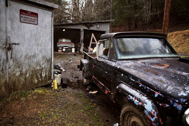 Vehicles and a warning sign that states: 'My bullets can outrun your 4 wheeler' outside the home of Jesse Boggess. He was awarded 16 different medals during service in the Vietnam War from 1969 to 197...