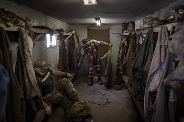 Miners change after their shift in a coal mine. The 32 miners work eight hour shifts but the working conditions are tough. They breath in dust while crawling through the low tunnels, many end up with...