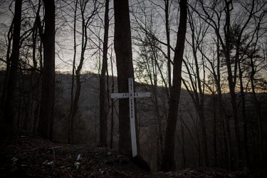 A cross at the roadside in the Appalachian mountains. Hard.Landis a journey through rust belt and blue collar America to meet the people struggling to keep the 'American Dream' alive: middle class peo...