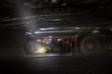 A miner drives a vehicle beneath ground in a coal mine. The 32 miners work eight hour shifts but the working conditions are tough. They breath in dust while crawling through the low tunnels, many end...