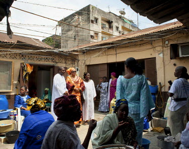 A Muslim ceremony being held in a communal courtyard in Abidjan.