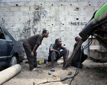 Men working in a car garage in Abidjan.