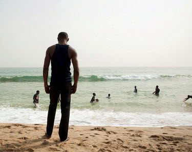 People swim and relax at the beach in Abidjan.