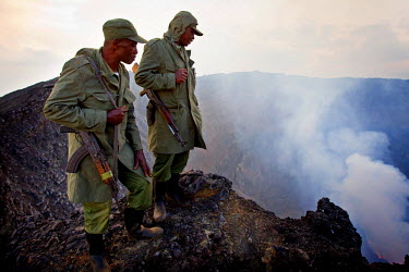 Guards stand on the rim of the Nyiragongo Volcano in the Virunga National Park. The stratovolcano is famous for its lava lake.
