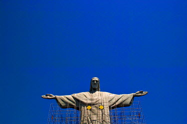 The statue of Christ the Redeemer, encased in scaffold for renovations, overlooking the city from the top of Corcovado mountain.