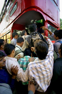 Commuters struggle onto a bus outside Victoria train stration.
