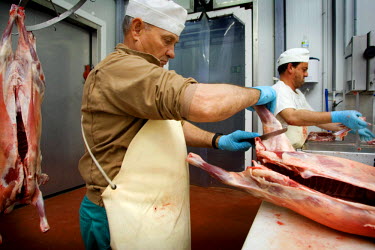 A Halal butcher cutting up meat.