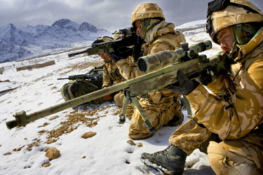 British Gurkha troops check the area with sniper guns as they secure their position.