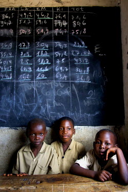 Three boys sit at the back of their classroom ina UNICEF supported school.