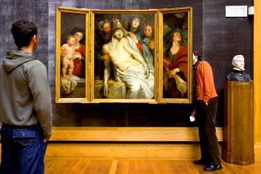 Visitors to the Museum of Fine Arts examine a work of art by Peter Paul Rubens.