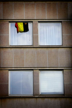A Belgian flag hangs from a window in the region where friction between the Flemish and Walloons continues.