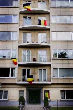 Belgian flags hang from apartment windows in the region where friction between the Flemish and Walloons continues.