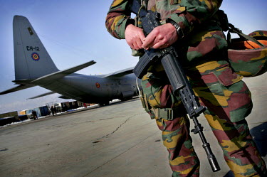 Belgian International Security Assistance Force (ISAF) soldiers guarding a C-130 transport aeroplane at Kabul airport.