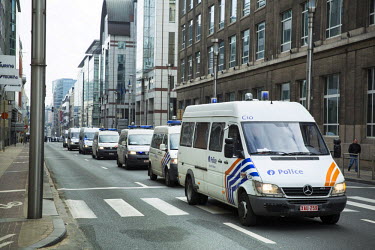 Police cars line up near the Rue de la Loi / Wetstraat in the centre of Brussels near the headquarters of the European Commission, the scene of a terrorist bombing in the Maalbeek Metro station on 22...