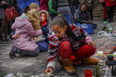 Sonia, 33 and her two children Alessia, 10 and Matteo, 7 mourn the victims of the terrorist attacks of 22nd March 2016 in front of the Bourse (Stock Exchange) in central Brussels.  On 22 March 2016 tw...