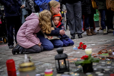 Sonia, 33 and her two children Alessia, 10 and Matteo, 7 mourn the victims of the terrorist attacks of 22nd March 2016 in front of the Bourse (Stock Exchange) in central Brussels.  On 22 March 2016 tw...