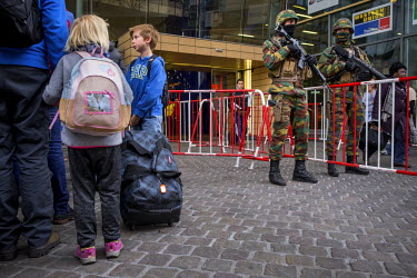 Armed Belgian soldiers guard the international railway station at Brussels South (Bruxelles Midi) as passengers arrive to board their train.  On 22 March 2016 two terrorist suicide attacks - at Brusse...