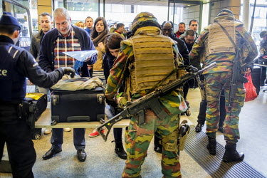 Belgian soldiers and police search the luggage of people arriving at Bruxelles Midi (Brussels South) international railway station on the day after the terrorist attacks.  On 22 March 2016 two terrori...