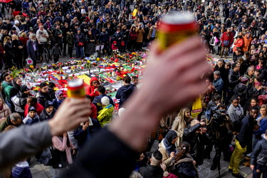 People gather in front of the Bourse (Stock Exchange) in central Brussels to pay their respects to the victims of the Brussels terrorist attacks and to show solidarity. Tributes and flowers have been...