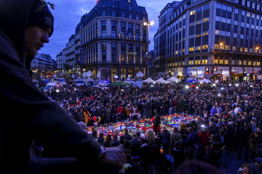 People gather in front of the Bourse (Stock Exchange) in central Brussels to pay their respects to the victims of the Brussels terrorist attacks and to show solidarity. Tributes and flowers have been...