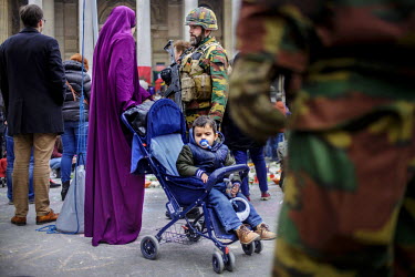 A soldier talks with a Muslim woman who has come to pay her respect to the victims of the 22 March terrorist attack at an impromptu shrine in front of the Bourse (the Stock Exchange) building.On 22 Ma...