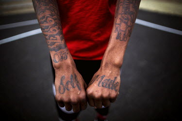 A youth playing basketball shows his tattoos, including 'Self Made' on his hands. Youngstown is in the Rust Belt and was a centre of steel production. It was forced to redefine itself when the U.S. st...