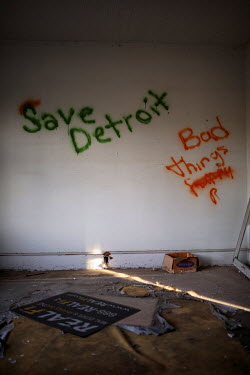 'Save Detroit' graffiti in an abandoned house. One of at least 70,000 abandoned buildings including 31,000 empty houses and 90,000 vacant lots. Hard.Land is a journey through rust belt and blue collar...