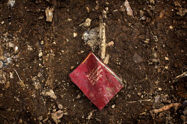 A book lying on the ground in a demolished house. Its title page reads: 'You Can Live Forever on Paradise on Earth.' Hard.Landis a journey through rust belt and blue collar America to meet the people...