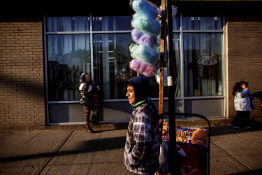 Rolando (11) and his mother Maria Arrojo selling candy floss (cotton candy) outside a primary school. Hard.Land is a journey through rust belt and blue collar America to meet the people struggling to...