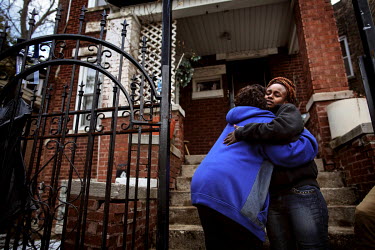 Rose Thompson (25 years old) gives her mother a big hug outside the house where the whole family lives. She lives with her child and husband in one room in the basement. Rose works at McDonald's and e...