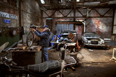 Alan Hill with an old bicycle in the ruined interior of the former Packard Automotive Plant where he has been living for several years with no running water or electricity. He claims to be in charge o...