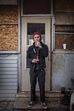 24 year old Jacob Cohron outside the front door of the house he lives in on Goldengate Street. Hard.Land is a journey through rust belt and blue collar America to meet the people struggling to keep th...