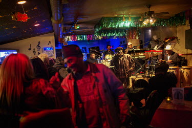 A band plays late into the night in a bar. Hard.Land is a journey through rust belt and blue collar America to meet the people struggling to keep the 'American Dream' alive: middle class people, the u...
