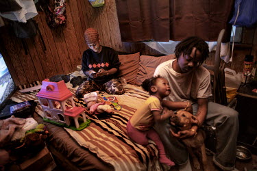 Rose Thompson (25) sits on a bed in a room which she rents from her grandmother. Rose, her husband and daughter live together in this room where there is only room for a bed and a TV. She works at McD...