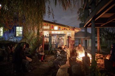 People gather to play drums outside the Psychedelic Healing Shack and Cafe in Goldengate Street. The area around Goldengate Street has been occupied by young people and hippies who redecorate the dest...