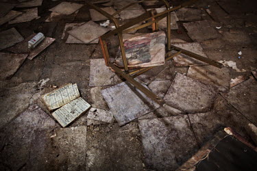 Hymm books and a broken chair on the floor in one of several abandoned churches in the city centre. Numerous public buildings, churches, factories and shops have been closed down and left unguarded fo...