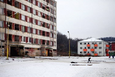 A child plays on the frozen ground outside a block in the Lunik IX housing estate, a decrepit complex almost entirely populated by Roma (6542 residents registered as living there in 2015). The concret...