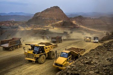 Dump trucks carry waste from the Kyaing International jade mine. According to a 2015 report on jade by London-based NGO Global Witness, Kyaing International is owned by the family of former military d...