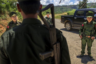 The commander of the Kachin Independence Army (KIA) battalion-6, U Tang Tsang (L), talks to a KIA soldier at a checkpoint in Aung Bar Lay village. The KIA battalion-6 used to have control over two sma...