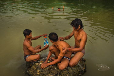 At the end of a day, a group of freelance jade miners, high after heroin injections, take a bath in a lake which was formed by large-scale mining.