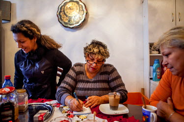 52 year old Maria with her daughter (left) and friend Darina in her flat in the Lunik IX estate. Most of the buildings on the estate are in appalling condition but the block she lives in is one of the...