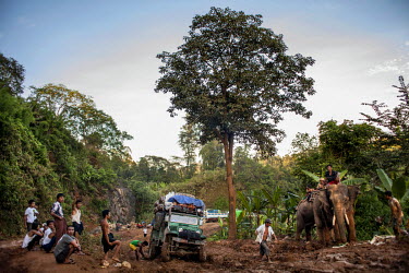 Somewhere along the 'jade trading road' between Hpakant and Myitkyina, a truck stuck in the mud waits to get pulled out by elephants. Armed conflict between the Burmese military and the Kachin Indepen...