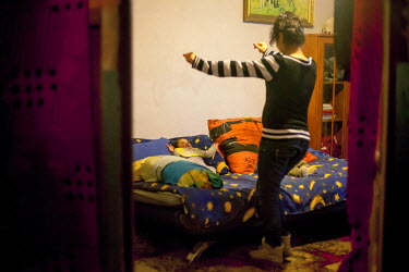 A young mother dances to amuse her baby in their flat on the Lunik IX housing estate. The decrepit complex is almost entirely populated by Roma, with 6542 residents registered in 2015. Living conditio...