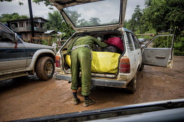 A soldier from the Myanmar military searches a vehicle for smuggled jade at a military check- point between Hpakant to Myitkyina, the capital of Kachin State.