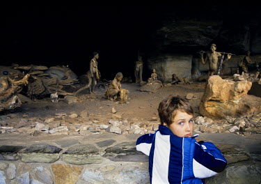 A boy visiting the Giants Castle Bushmen Cave Museum looks at a display.