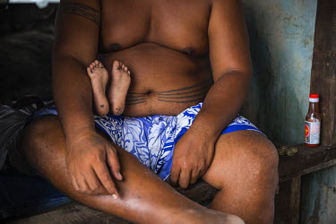 A father and son in a house in Lord Howe Settlement, a district of the capital Honaria which is populated by people from Ontong Java Atoll (AKA Lord Howe Atoll), a Polynesian outlier of the Solomon Is...