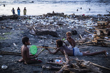 Children playing with toy guns fashioned from drift wood on the beach in Lord Howe Settlement, a district of the capital Honaria populated by people from Ontong Java Atoll (AKA Lord Howe Atoll), a Pol...