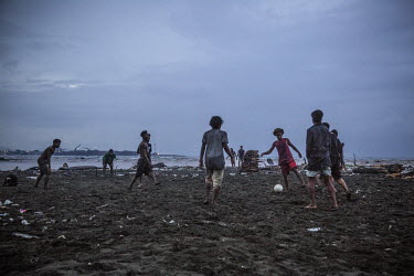 Young people play football on a beach in Lord Howe Settlement, a district of the capital Honaria which is populated by people from Ontong Java Atoll (AKA Lord Howe Atoll), a Polynesian outlier of the...