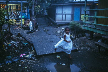 Isabella, six running through the labyrinth of streets in Lord Howe Settlement, a district of the capital Honaria which is populated by people from Ontong Java Atoll (AKA Lord Howe Atoll), a Polynesia...